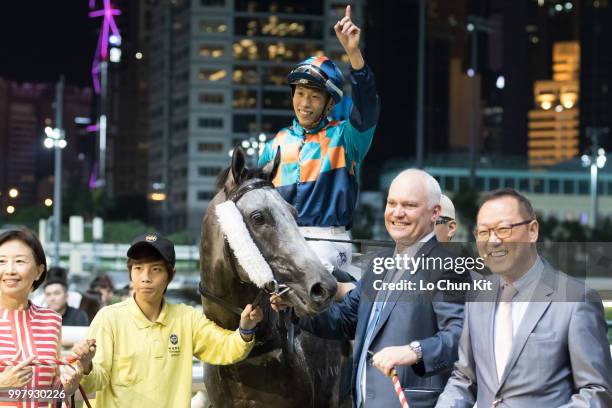 Jockey Vincent Ho Chak-yiu, trainer David Hall and owners celebrate after Super Turbo winning the Race 7 Sun Jewellery Handicap at Happy Valley...