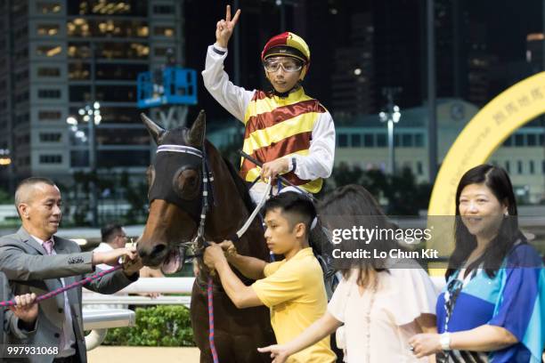 Jockey Matthew Poon Ming-fai and owners celebrate after Buoyant Boy winning the Race 8 Silver Grecian Handicap at Happy Valley Racecourse on July 11,...