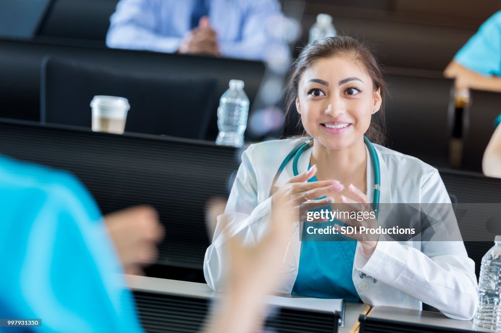 Hispanic healthcare professional attending continuing education seminar