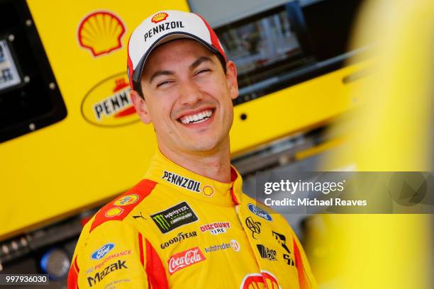 Joey Logano, driver of the Shell Pennzoil Ford, stands in the garage area during practice for the Monster Energy NASCAR Cup Series Quaker State 400...