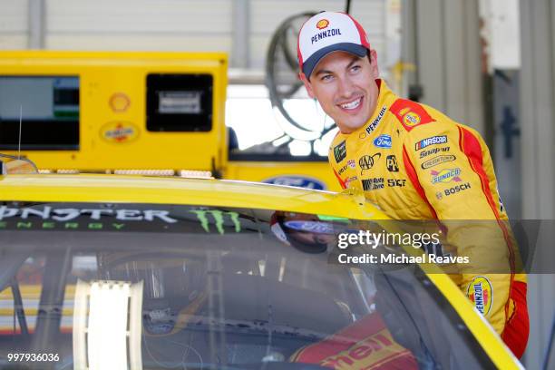 Joey Logano, driver of the Shell Pennzoil Ford, stands in the garage area during practice for the Monster Energy NASCAR Cup Series Quaker State 400...