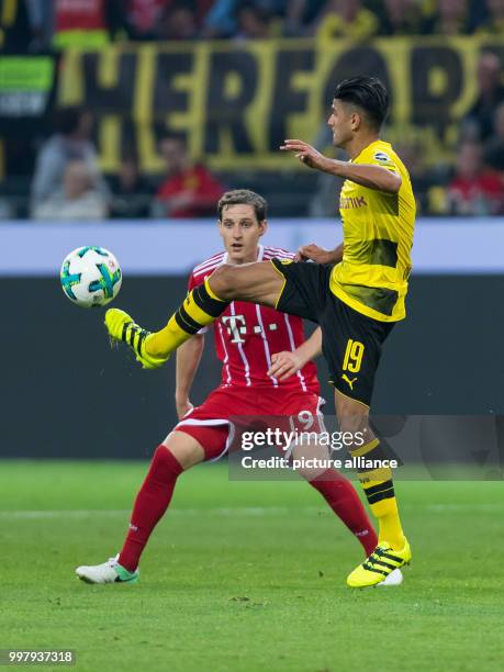 Bayern's Sebastian Rudy and Dortmund's Mahmoud Dahoud vie for the ball during the DFL-Supercup match between Borussia Dortmund and Bayern Muenchen in...