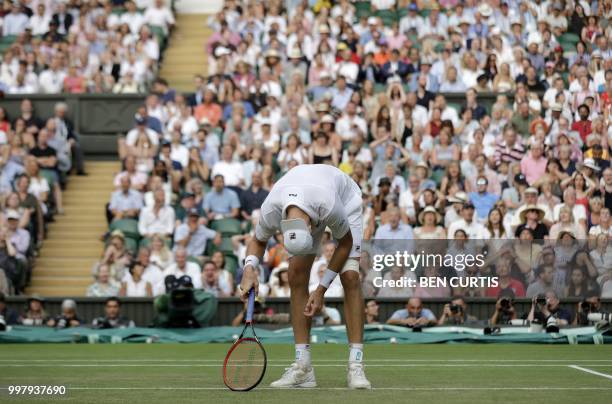 Player John Isner reacts after losing a point against South Africa's Kevin Anderson during the final set tie-break of their men's singles semi-final...