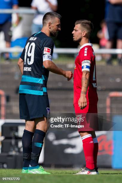 Vedad Ibisevic of Hertha BSC and Kevin Wolze of Duisburg look on after the TEDi-Cup match between Hertha BSC and MSV Duisburg on July 8, 2018 in...
