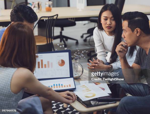 young asian coworkers in serious business meeting with team discussion brainstorming, startup project presentation or teamwork concept, at office - customer intelligence stock pictures, royalty-free photos & images