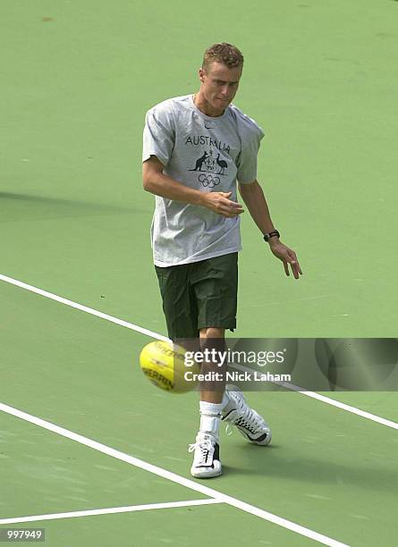 Lleyton Hewitt of Australia warms up with an Australian Rules Football during the Australian Davis Cup squad's training session held at the Sydney...