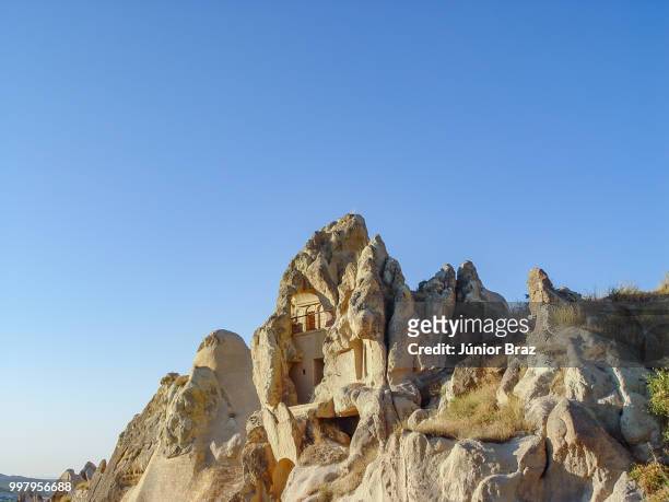 volcanic cliffs and rock formations at cappadocia - rock hoodoo stockfoto's en -beelden