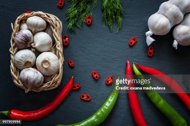 garlic, pepper and herbs on the board slate - medvedeva ストックフォトと画像
