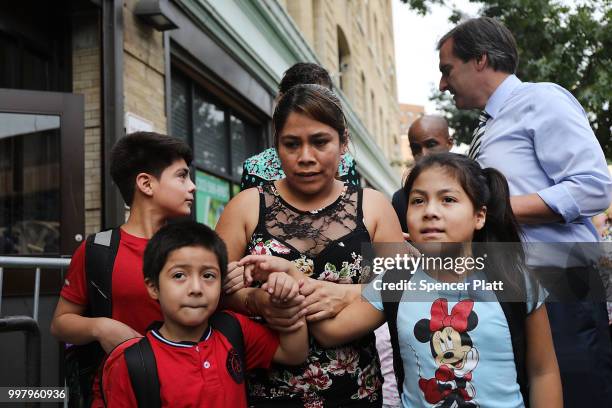 Yeni Maricela Gonzalez Garcia stands with her children 6 year-old Deyuin , 9 year-old Jamelin and 11 year-old Lester as she and her lawyer speak with...
