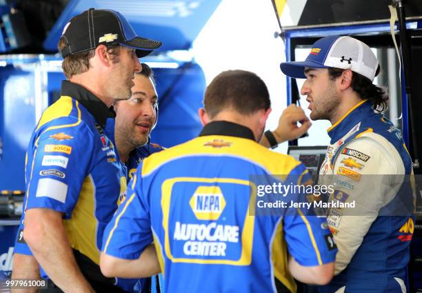 Chase Elliott, driver of the NAPA Auto Parts Chevrolet, talks to crew members in the garage area during practice for the Monster Energy NASCAR Cup...