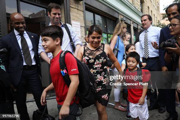 Yeni Maricela Gonzalez Garcia stands with her children 6 year-old Deyuin 11 year-old Lester and 9 year-old Jamelin as she and her lawyer speak with...