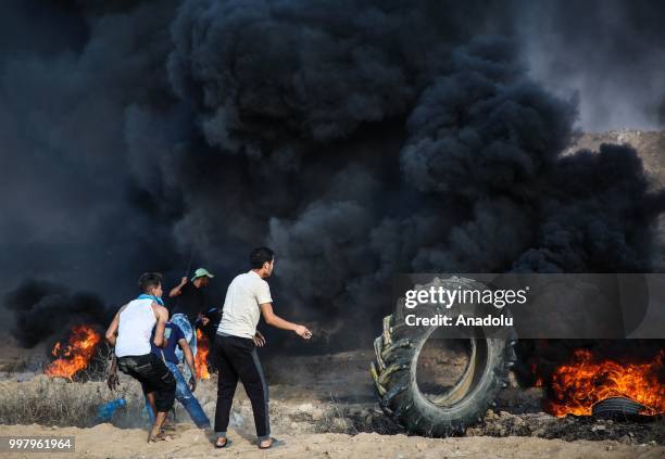 Palestinian demonstrators take part in the "Great March of Return" demonstration with ''Fidelity to Khan Al-Ahmar'' near Israel-Gaza border at...