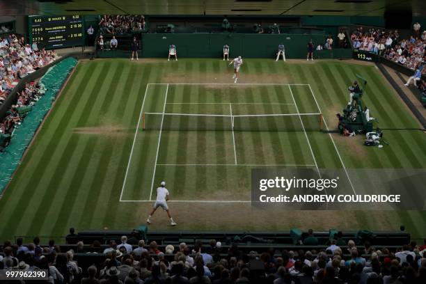 Player John Isner serves against South Africa's Kevin Anderson during the final set tie-break of their men's singles semi-final match on the eleventh...