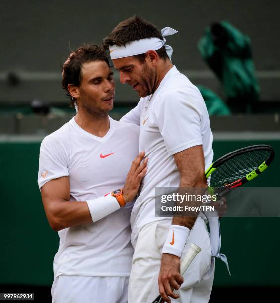 Rafael Nadal of Spain commiserates with Juan Martin Del Potro of Argentina after the gentlemen's quarter finals at the All England Lawn Tennis and...