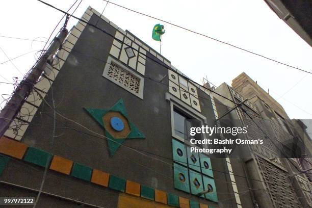 narrowed streets of lyari are painted with national flags of different countries playing fifa world cup 2018 - bashir stock-fotos und bilder