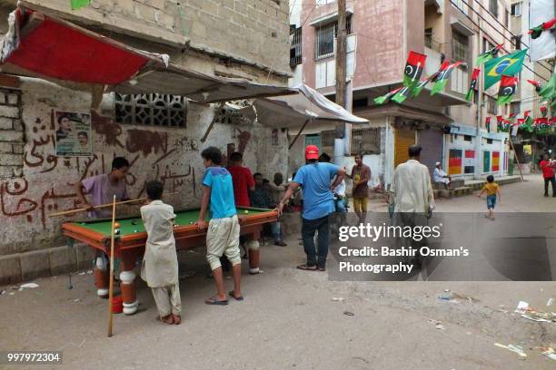 narrowed streets of lyari are painted with national flags of different countries playing fifa world cup 2018 - bashir stock-fotos und bilder