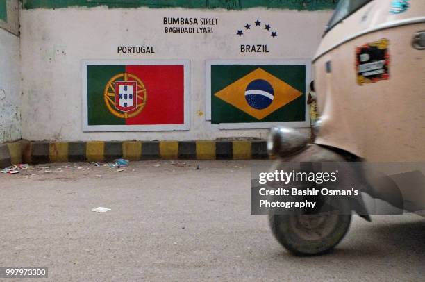 narrowed streets of lyari are painted with national flags of different countries playing fifa world cup 2018 - bashir stock-fotos und bilder