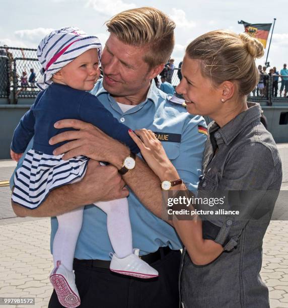 Lieutenant commander Carl Graue from Varel says goodbye to his ten-months old daughter Mathilda and his wife Luisa Tenner in front of the frigate...