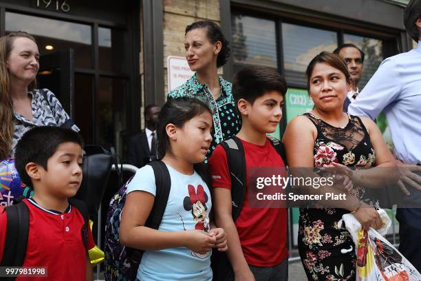 Yeni Maricela Gonzalez Garcia stands with her children 6 year-old Deyuin, 9 year-old Jamelin and 11 year-old Lester as she and her lawyer speak with...