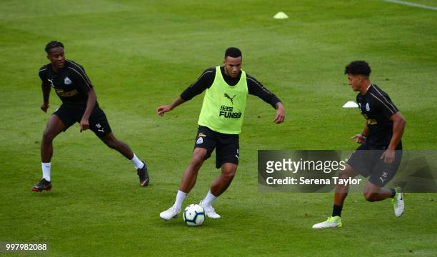 Jamaal Lascelles controls the ball whilst being challenged by Rolando Aarons and Josef Yarney during the Newcastle United Training session at Carton...