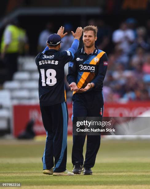 Lockie Ferguson of Derbyshire celebrates with Alex Hughes after getting a wicket during the Vitality Blast match between Derbyshire Falcons and Notts...