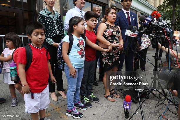Yeni Maricela Gonzalez Garcia stands with her children 6 year-old Deyuin , 9 year-old Jamelin and 11 year-old Lester as she and her lawyer speak with...