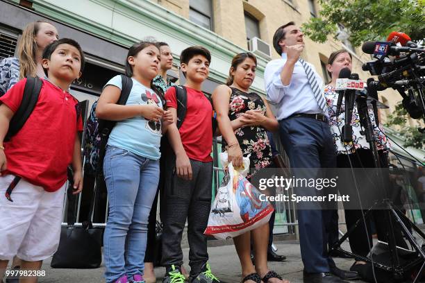 Yeni Maricela Gonzalez Garcia stands with her children 6 year-old Deyuin, 9 year-old Jamelin and 11 year-old Lester as she and her lawyer speak with...