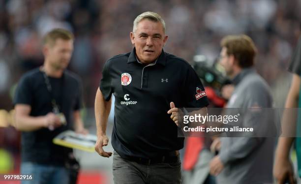 Pauli's coach Olaf Janssen is walking on the pitch before the German 2nd Bundesliga soccer match between 1. FC St Pauli and Dynamo Dresden in the...