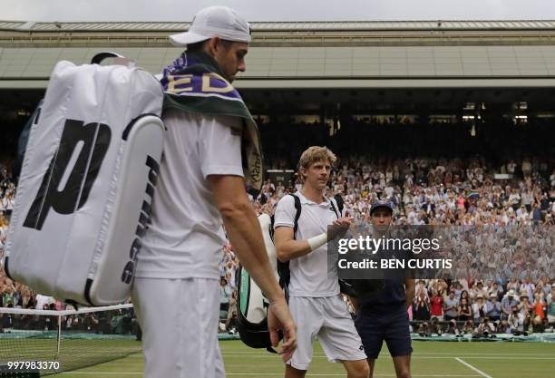 Player John Isner and South Africa's Kevin Anderson leave the court following the final set tie-break of their men's singles semi-final match on the...