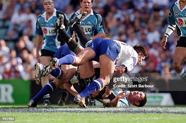 Andrew Pierce for the Sharks is hit hard by the Bulldogs defence during the NRL second semi final match played between the Sharks and the Bulldogs...