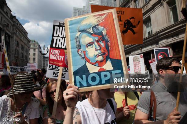 Tens of thousands of protesters gather to march and demonstrate at the Together Against Trump national demonstration on 13th July 2018 in London,...