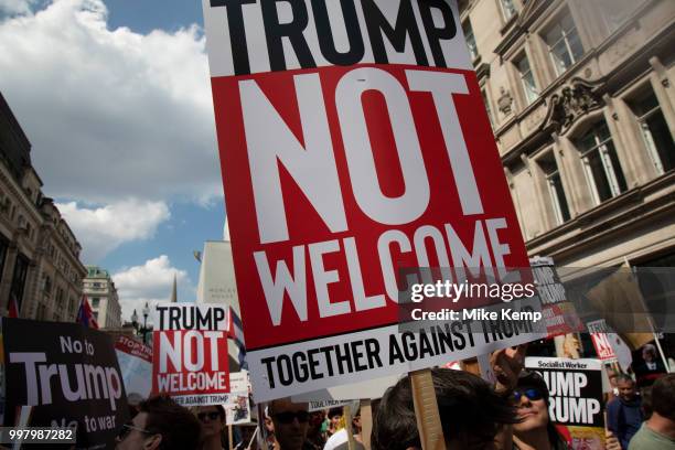 Tens of thousands of protesters gather to march and demonstrate at the Together Against Trump national demonstration on 13th July 2018 in London,...