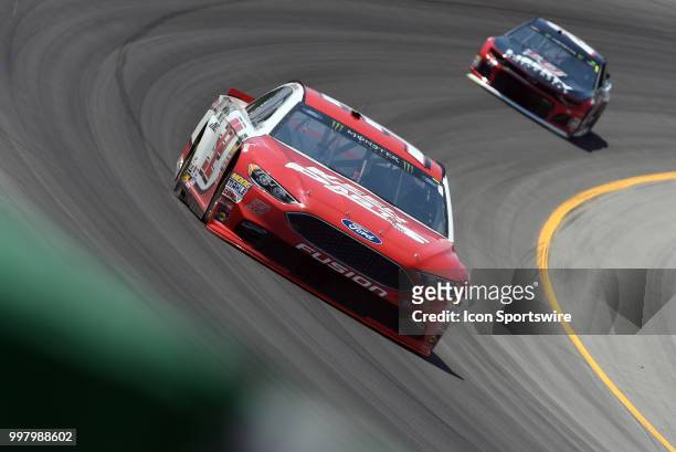 Matt DiBenedetto GO FAS Racing Ford Fusion and William Byron Hendrick Motorsports Chevrolet Camaro ZL1 drive through turn two during practice for the...