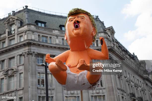 Tens of thousands of protesters gather to march and demonstrate at the Together Against Trump national demonstration on 13th July 2018 in London,...