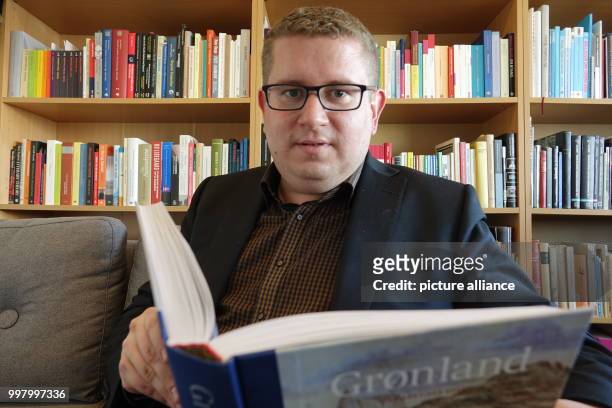 Ebbe Volquardsen, junior professor in cultural history at the University of Nuuk, with a book in his office in Nuuk, Greenland, 3 May 2017. Around 50...