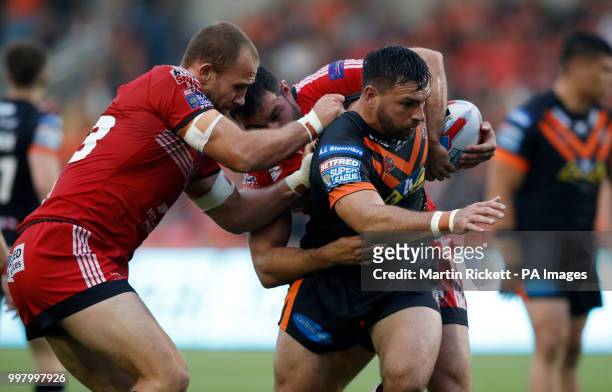 Castleford Tiger's Matt Cook is tackled by Salford Red Devils' Lee Mossop and Mark Flanagan during the Betfred Super League match at the AJ Bell...