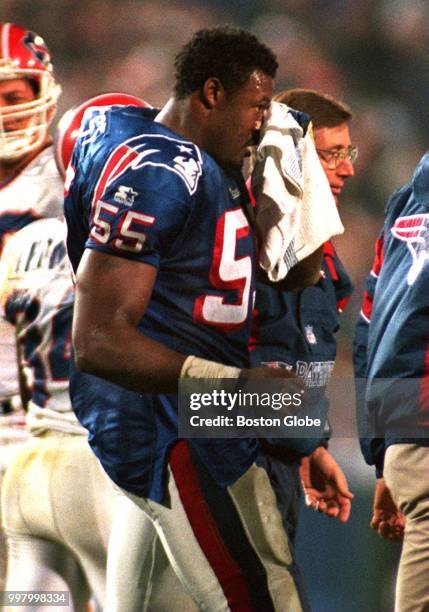 New England Patriots' Willie McGinest walks off the field after injuring his eye. The New England Patriots host the Buffalo Bills in a regular season...