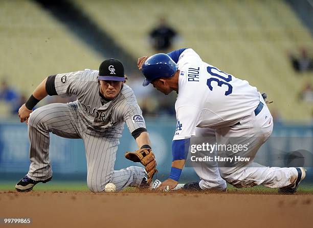 Xavier Paul of the Los Angeles Dodgers steals second base in front of Troy Tulowitzki of the Colorado Rockies during the first inning at Dodger...