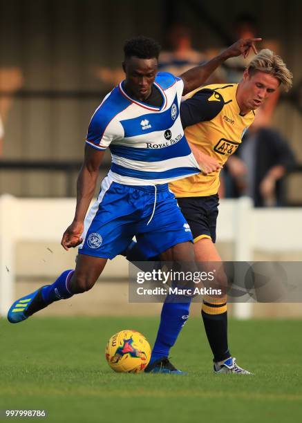 Idrissa Sylla of Queens Park Rangers in action with Bredan McVey of Staines Town during the Pre-Season Friendly between Staines Town and Queens Park...