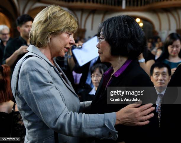 Former German President Joachim Gauck's partner Daniela Schadt chats with Chinese writer Tienchi Martin Liao during a commemoration for Chinese human...