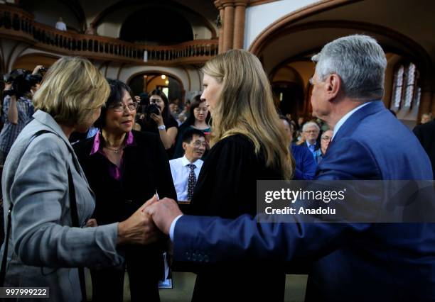 Former German President Joachim Gauck and his partner Daniela Schadt and Chinese writer Tienchi Martin Liao chat during a commemoration for Chinese...