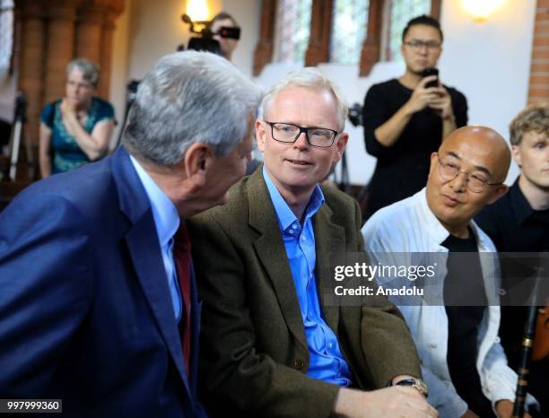 Former German President Joachim Gauck chats with Pulitzer Prize-winning author and journalist Ian Johnson during a commemoration for Chinese human...