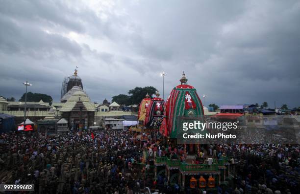 Devotees and police personnel pull the wooden chariots to set it in front of the Shree Jagannath temple on the eve of temple ditties annual chariot...
