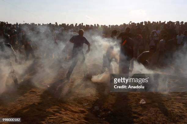 Israeli forces use tear gas to disperse Palestinian demonstrators taking part in the "Great March of Return" demonstration with ''Fidelity to Khan...