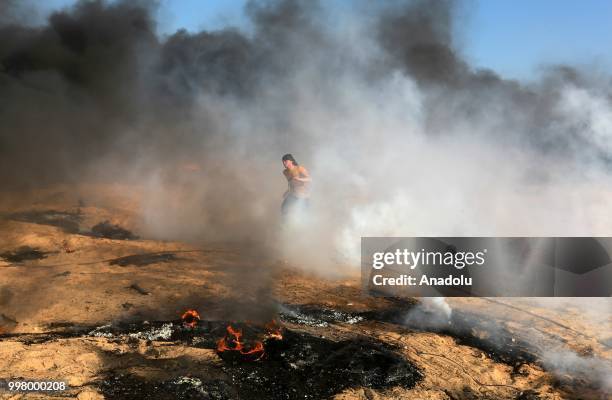 Palestinian demonstrators set tyres on fire as they take part in the "Great March of Return" demonstration with ''Fidelity to Khan Al-Ahmar'' near...