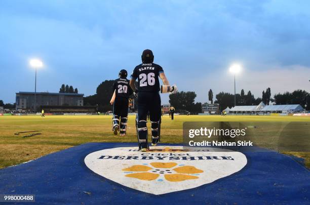 Matt Critchley and Ben Slater make their way to the pitch during the Vitality Blast match between Derbyshire Falcons and Notts Outlaws at The 3aaa...