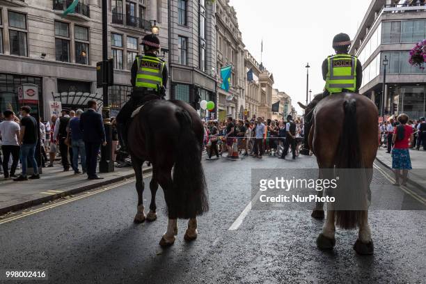 Riot police secure the march of crowds who protest against American president, Donald Trump visit to the UK in London on 13 of July, 2018. The...