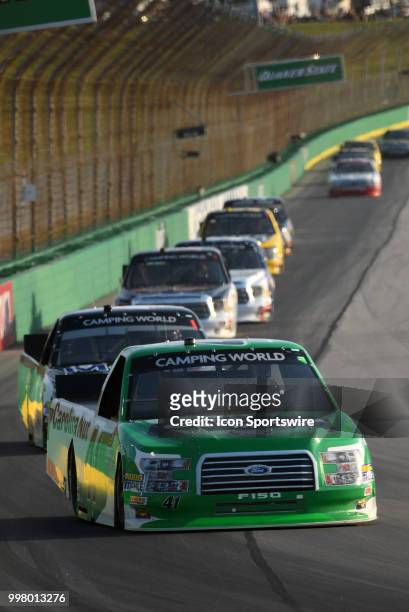 Ben Rhodes ThorSport Racing Ford F-150 leads a pack of trucks down the back stretch during the NASCAR Camping World Truck Series Buckle Up In Your...