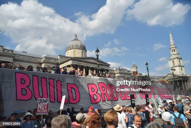 Demonstrators gather at Trafalgar Square as they attend a rally against the US President Donald Trumps visit to the UK, including a giant inflatable...