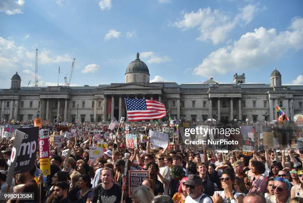 Demonstrators gather at Trafalgar Square as they attend a rally against the US President Donald Trumps visit to the UK, including a giant inflatable...